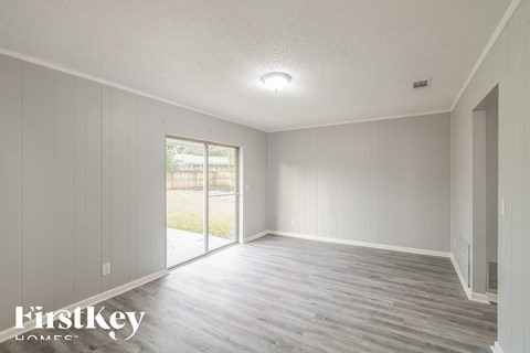 the living room of a new home with white walls and wood floors