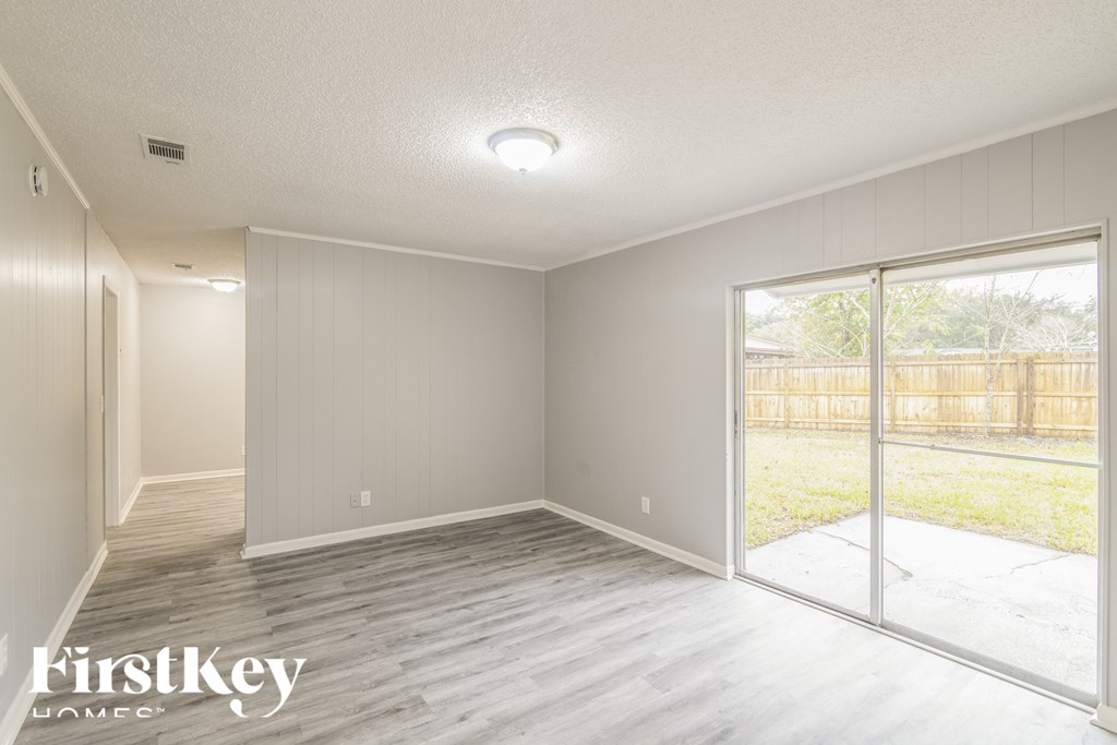 a living room with wood floors and a sliding glass door