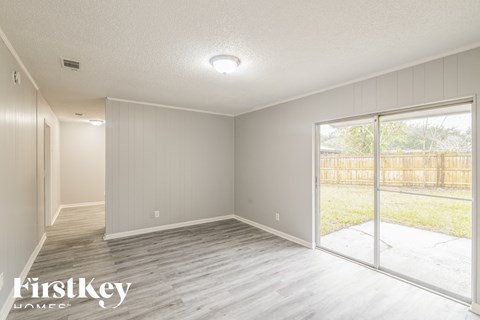 a living room with wood floors and a sliding glass door