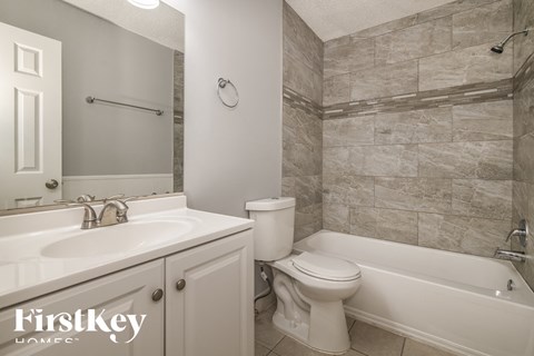 a bathroom with a sink toilet and a tub