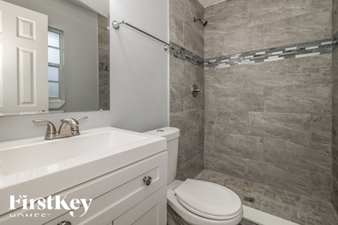 a bathroom with a toilet and a sink and a shower