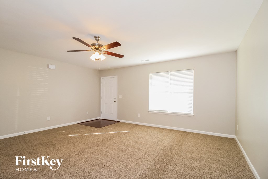 a bedroom with a ceiling fan and a white door