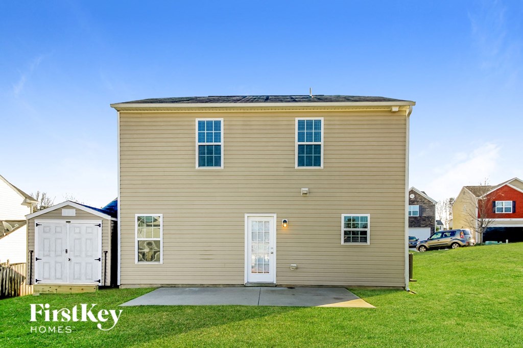 a small yellow house with a roof on top of it