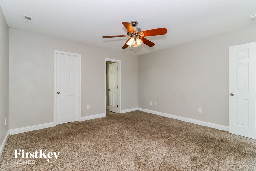 the master bedroom is spacious and has a ceiling fan