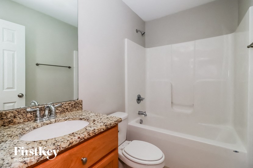 a bathroom with a sink and a toilet and a tub