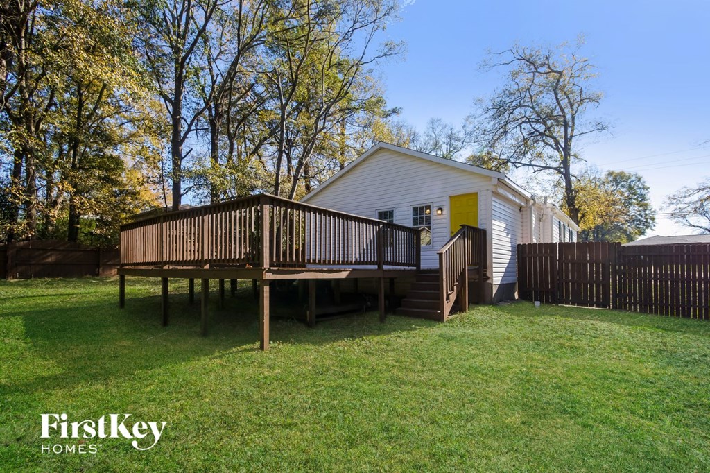 a small white house with a porch and a deck
