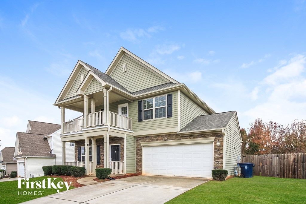 A two-story house with a garage is for sale.