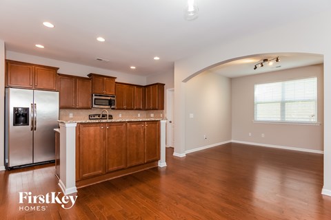 A kitchen with wooden cabinets and a refrigerator.