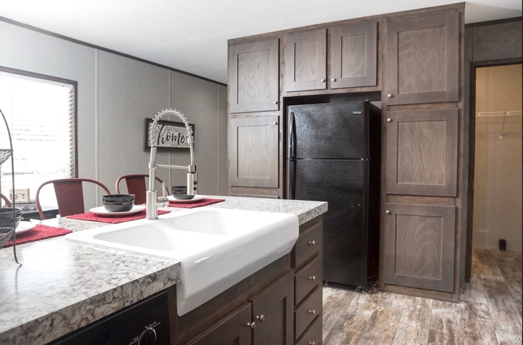 a kitchen with a sink and a refrigerator