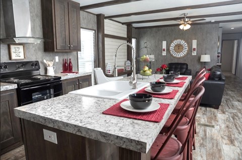 a kitchen with a large island and a table with chairs