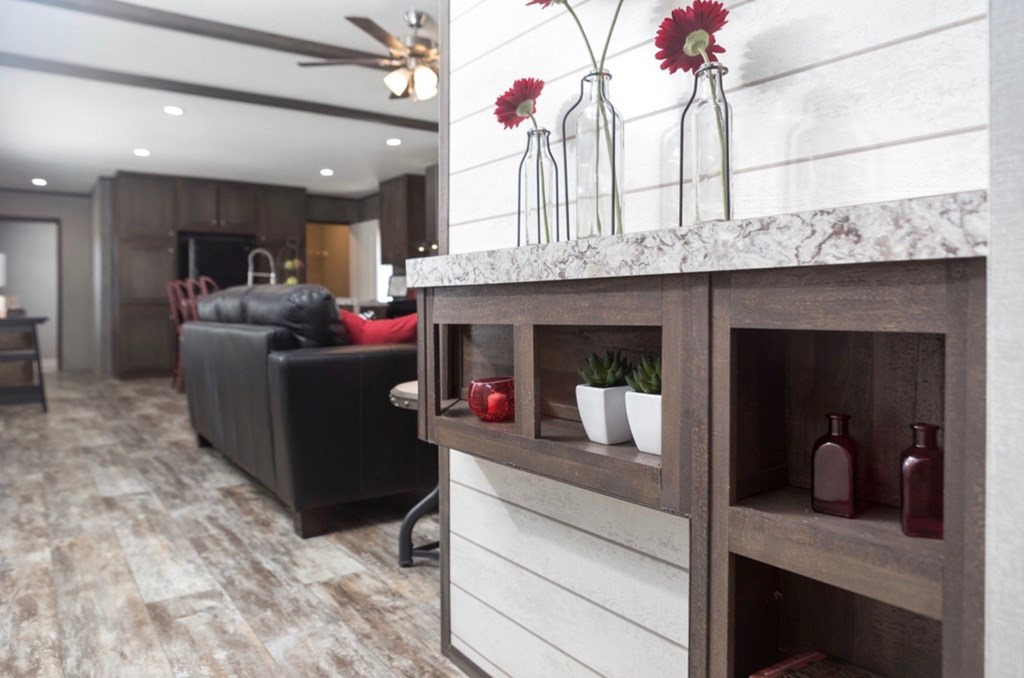 a kitchen with a counter and a living room