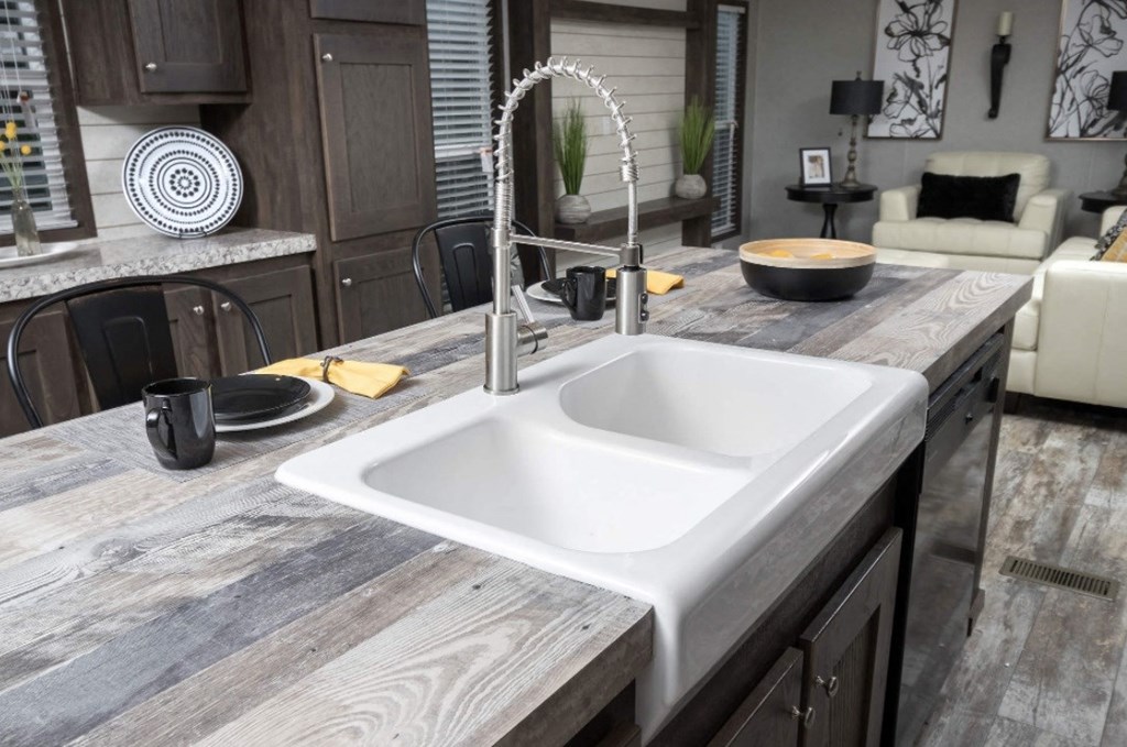 a kitchen with a sink and a counter top in a rv