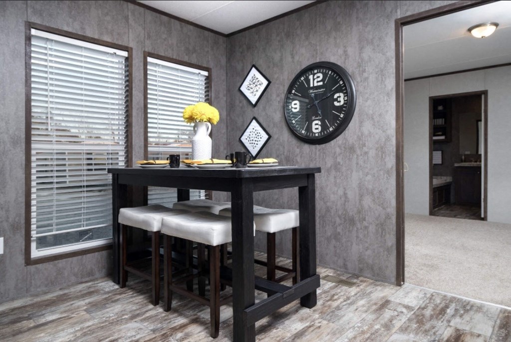 a dining room with a table and a clock on the wall