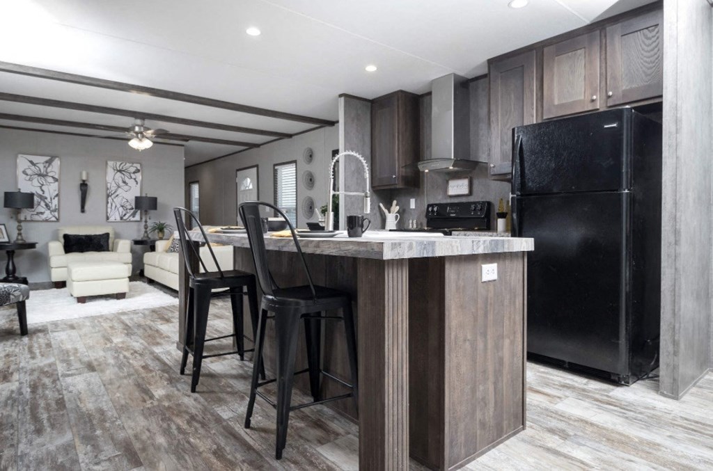 a kitchen with a center island and black appliances