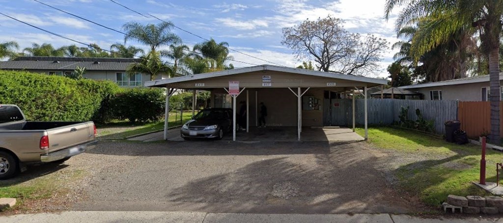 a car parked in a carport in front of a house