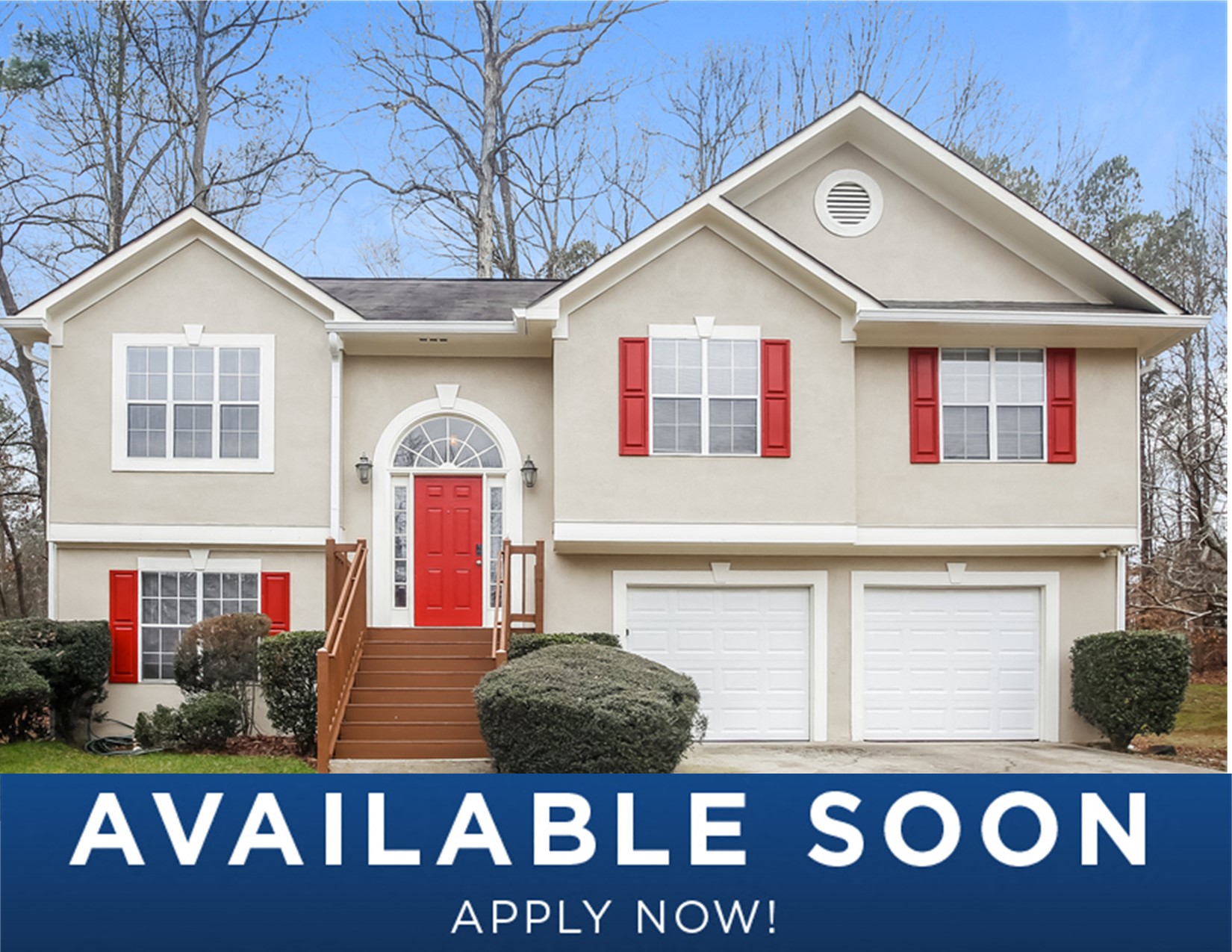 a beige house with red doors and a sign that reads available soon