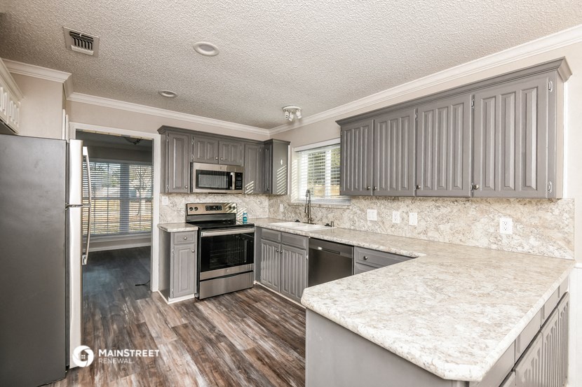 the kitchen has stainless steel appliances and marble counter tops