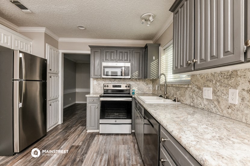 a kitchen with granite counter tops and stainless steel appliances