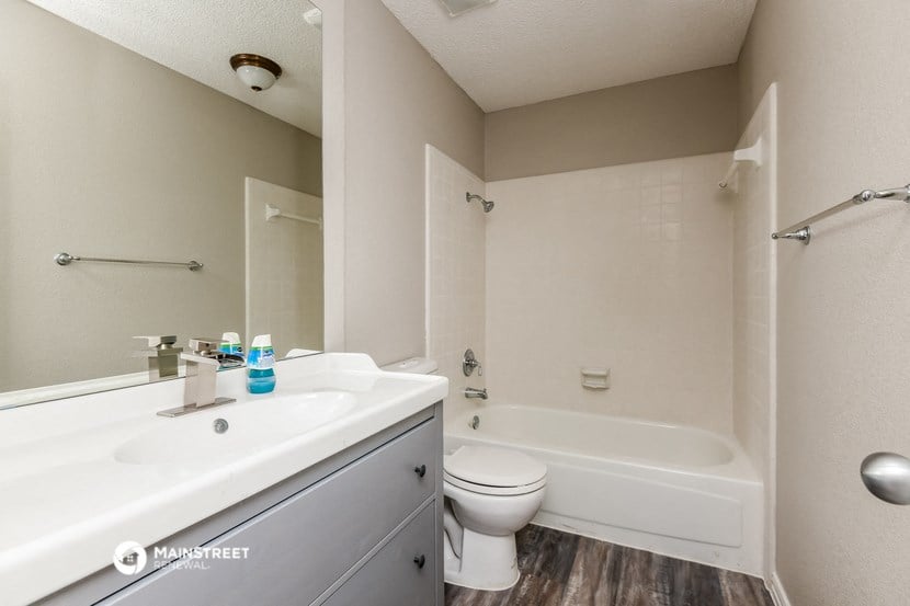 a bathroom with a sink and a toilet and a tub