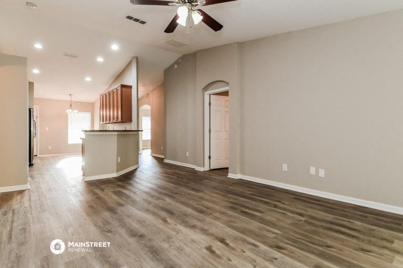 the living room is open to the kitchen and dining area