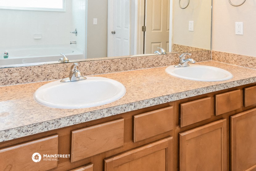 a bathroom with two sinks and a large mirror
