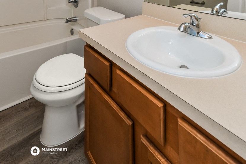 a bathroom with a toilet and a sink and a tub