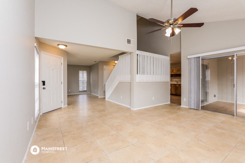 the spacious living room and dining room with stairs to the upper level
