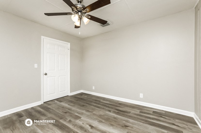 the living room of a home with a ceiling fan