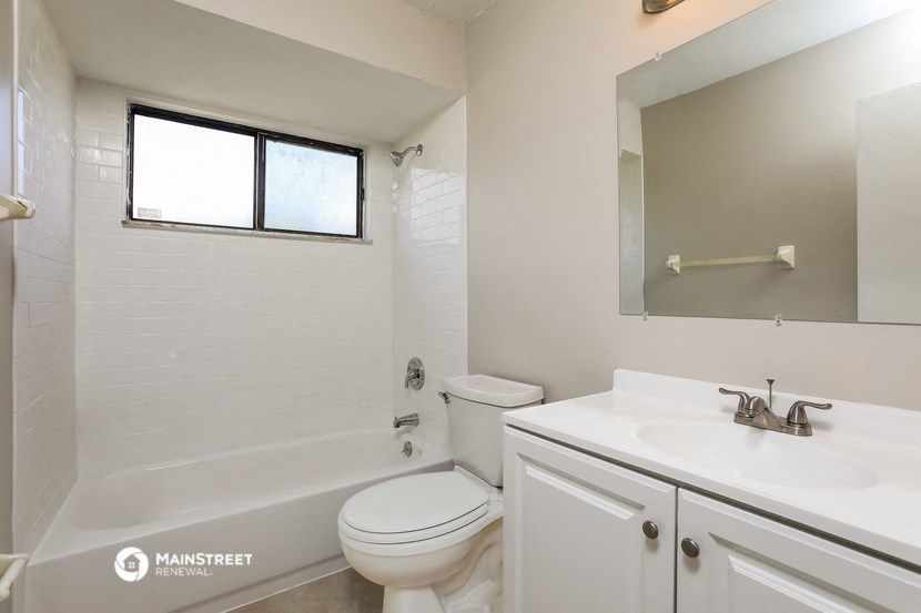 a bathroom with a sink toilet and a bath tub