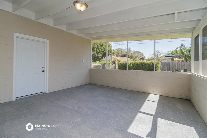 an empty room with a white door and window