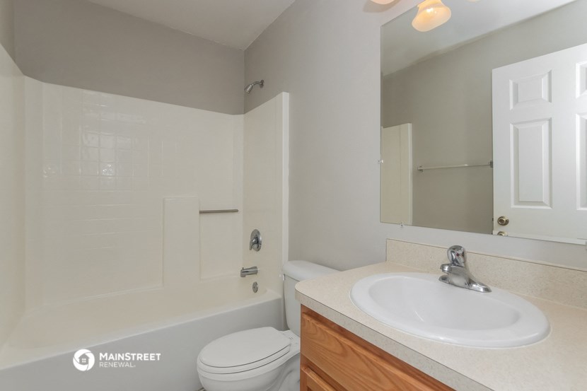 a bathroom with a sink and a toilet and a tub