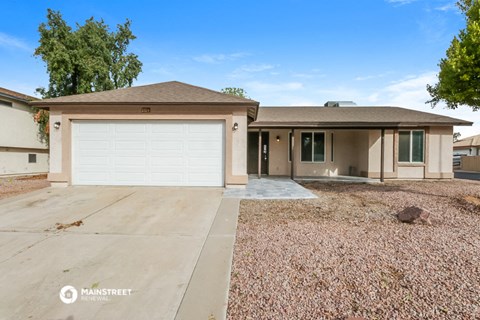 a beige house with a white garage door