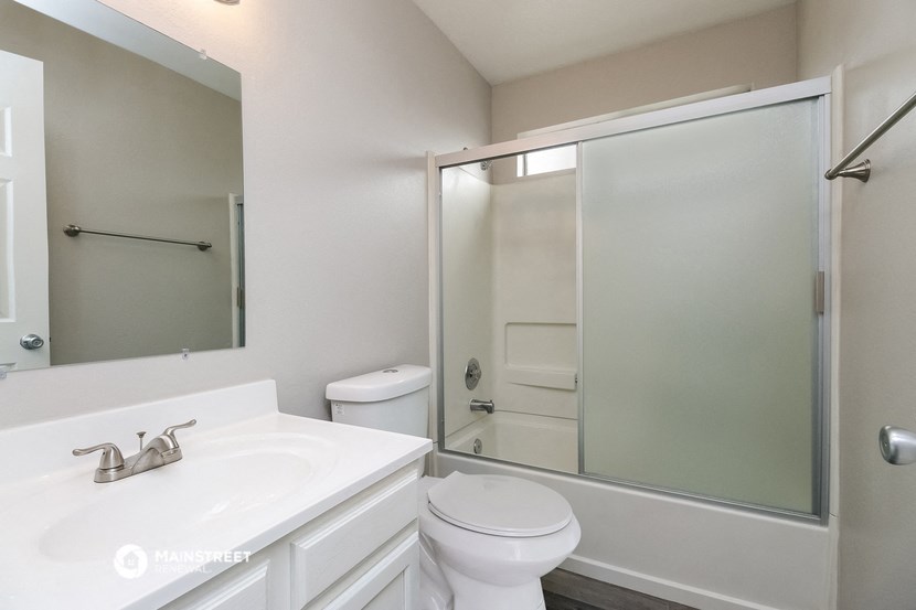 a bathroom with a sink toilet and a shower
