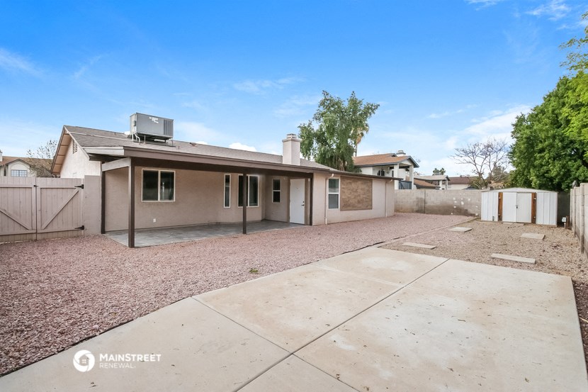 a home with a driveway and a house with a roof