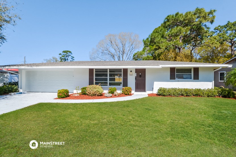 a white house with a lawn in front of it