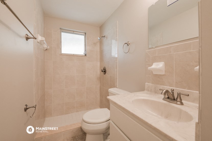 a bathroom with a sink toilet and a shower