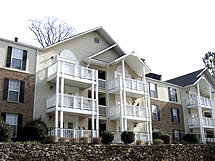 Apartment building with a white balcony.