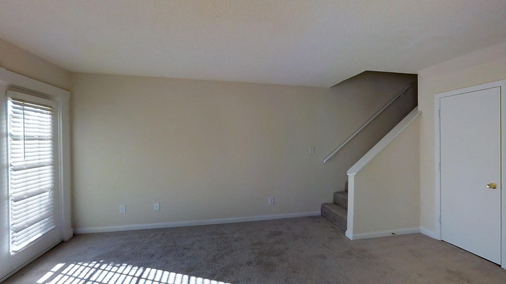 A room with a staircase and a door.