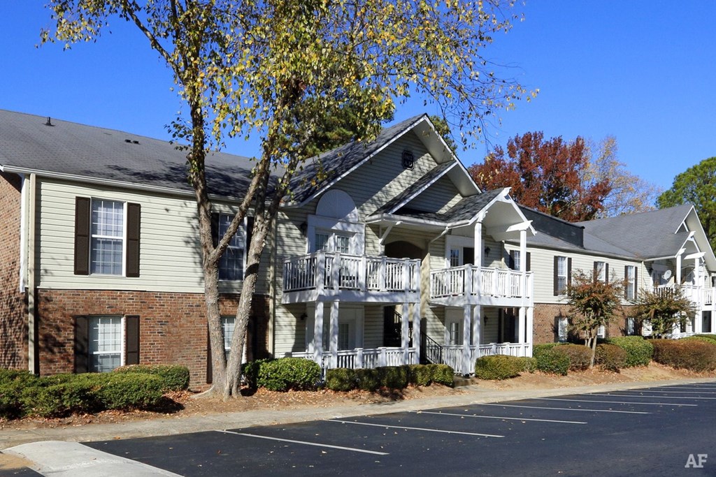 A row of houses with a tree in front of them.
