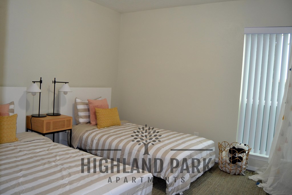 two twin beds in a room with a window