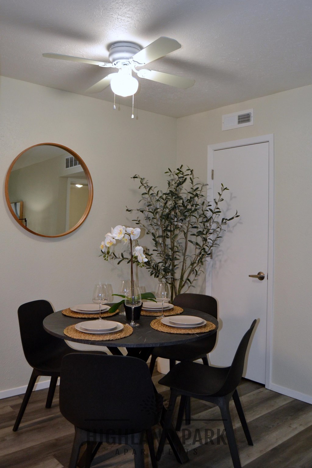 a dining room with a table and chairs and a ceiling fan