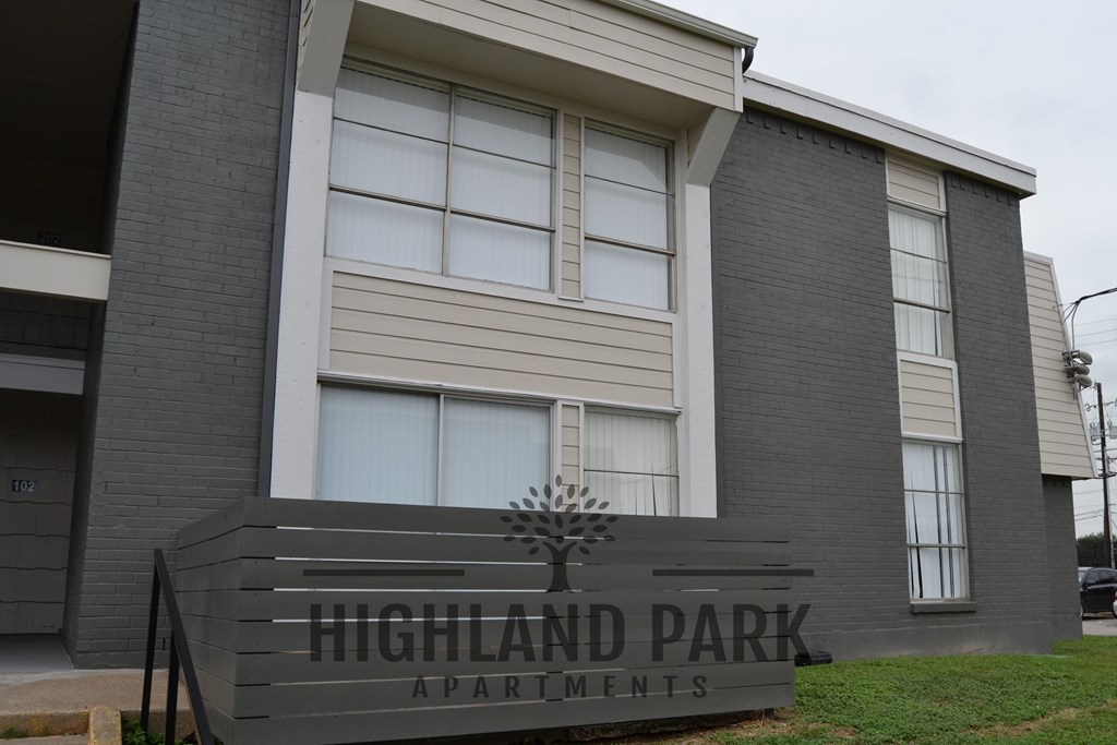 a building with a sign for highland park apartments