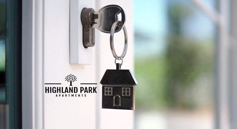 a keychain with a house keyring on a door handle