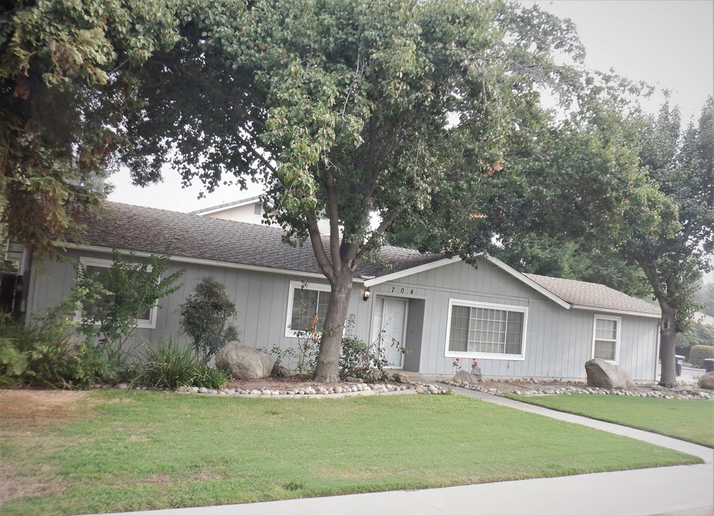 a white house with a tree in the front