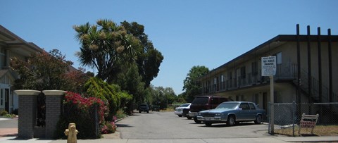 a street with cars parked in front of a building