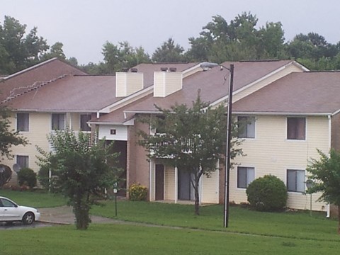an apartment building with a car parked outside of it