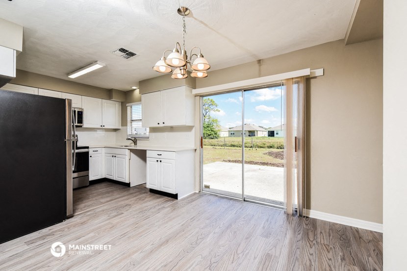 a kitchen with a sliding glass door to a patio