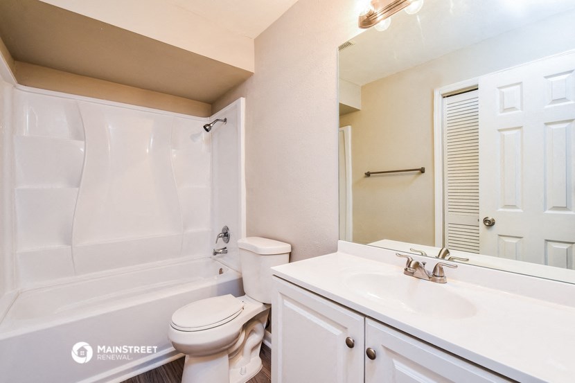 a bathroom with a sink toilet and a bath tub