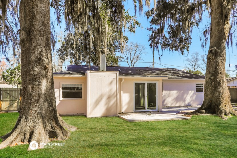 a small house with two trees in front of it