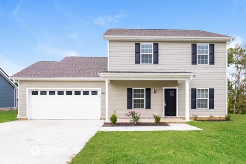 a white house with black shutters and a white garage door
